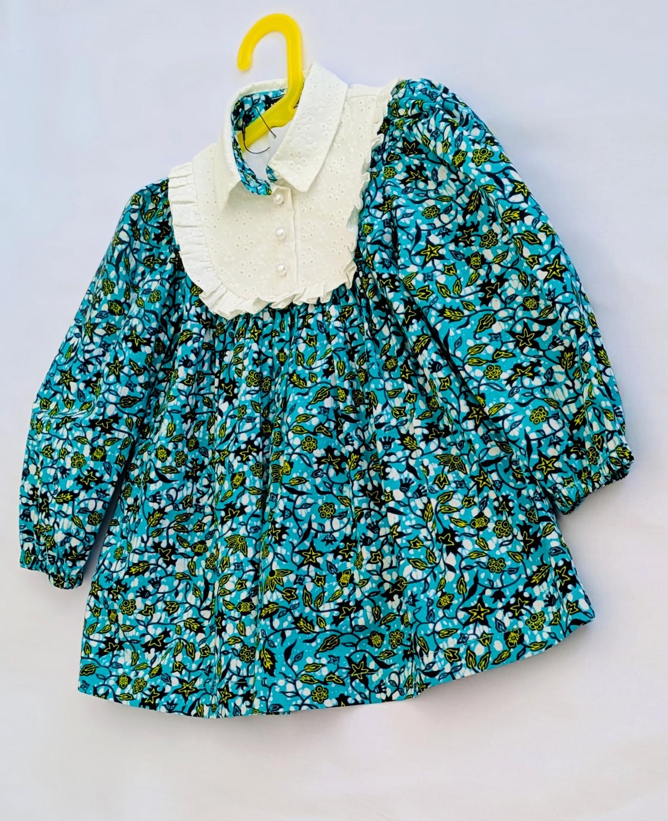 Mo & Ruby's teal floral dress flat lay on hanger